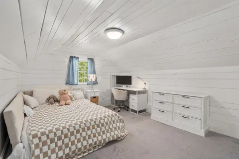 a bedroom with a bed and a chair