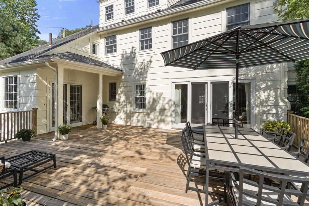 513 Chestnut Street Newton, MA 02468 - Photo 22 of 32 a view of a patio with table and chairs near a barbeque