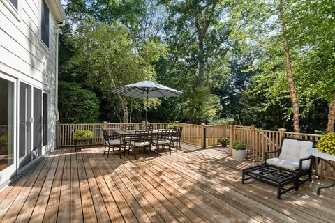 a view of backyard with seating area and trees