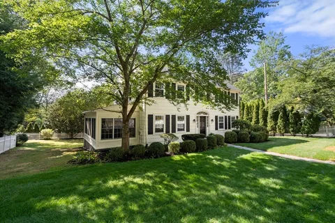 a front view of house with yard and green space