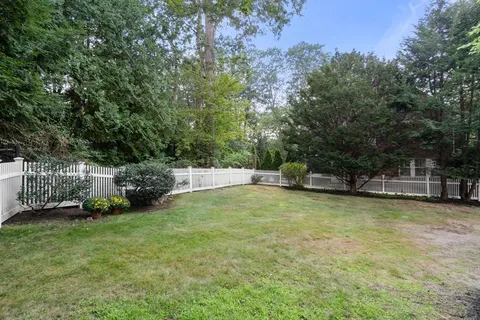 a view of a swimming pool with an outdoor seating and a forest