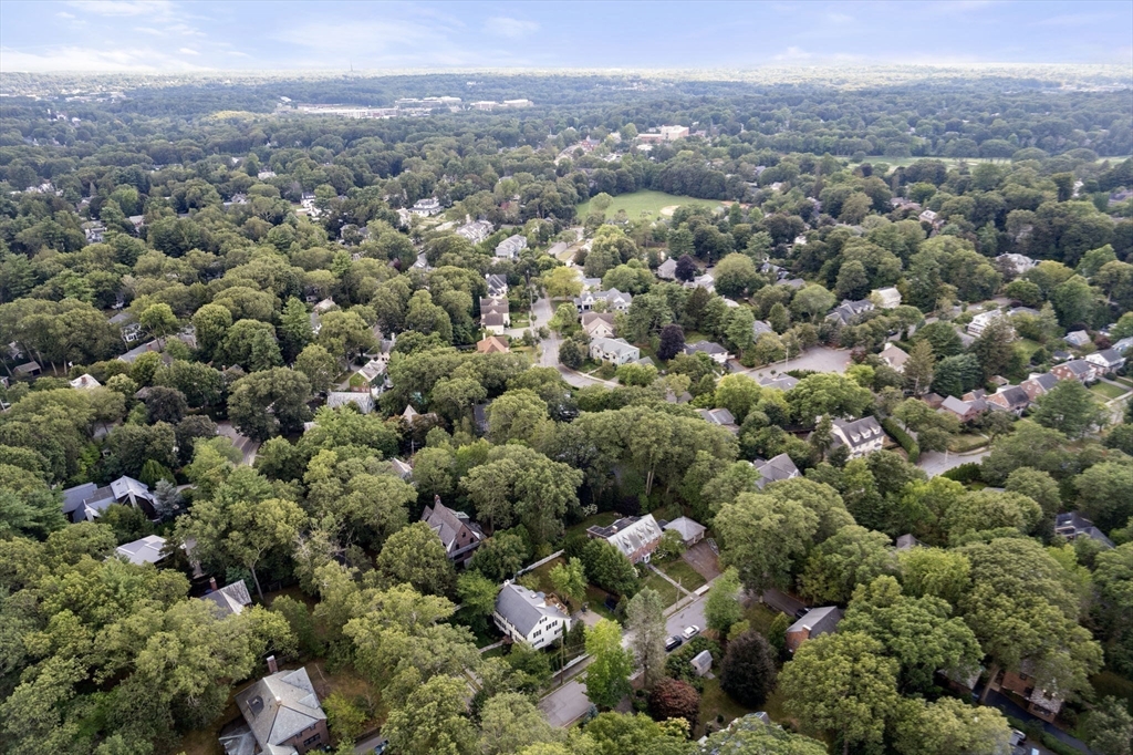 513 Chestnut Street Newton, MA 02468 - Photo 32 of 32 an aerial view of a houses with a green hillside