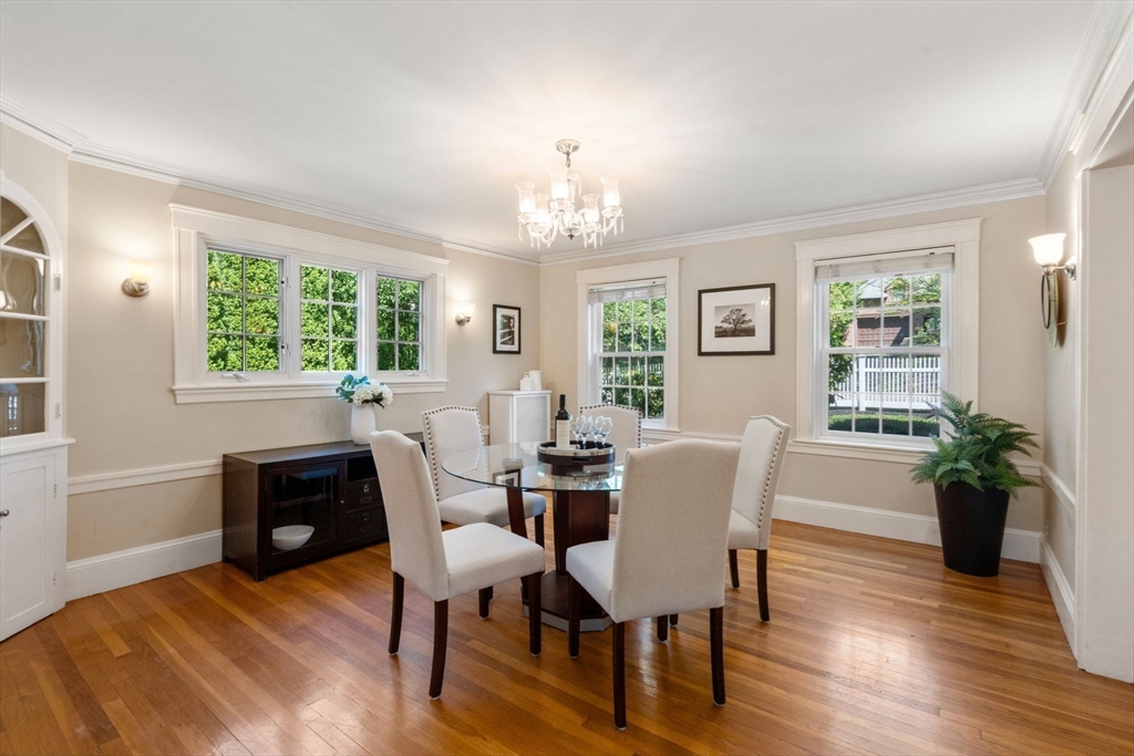 513 Chestnut Street Newton, MA 02468 - Photo 4 of 32 a view of a dining room with furniture a chandelier and wooden floor