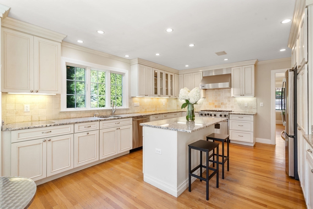 513 Chestnut Street Newton, MA 02468 - Photo 7 of 32 a kitchen with granite countertop appliances cabinets and wooden floor