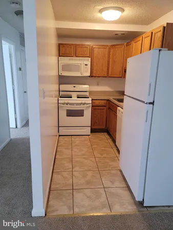 a kitchen with a refrigerator sink and stove