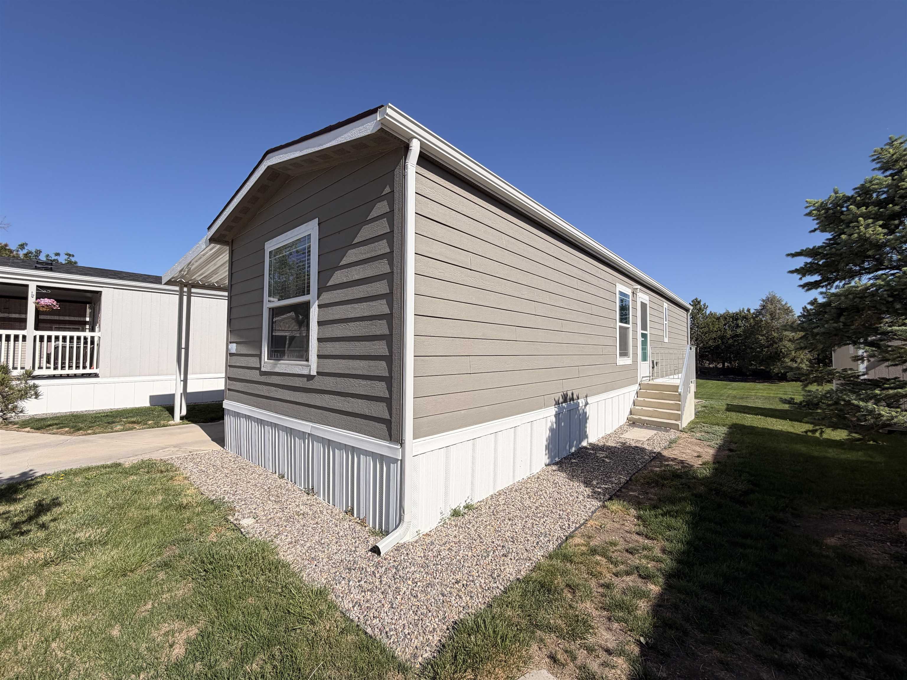 435 32 Road, Unit 826 Clifton, CO 81520 - Photo 16 of 17 a view of a house with backyard and trees