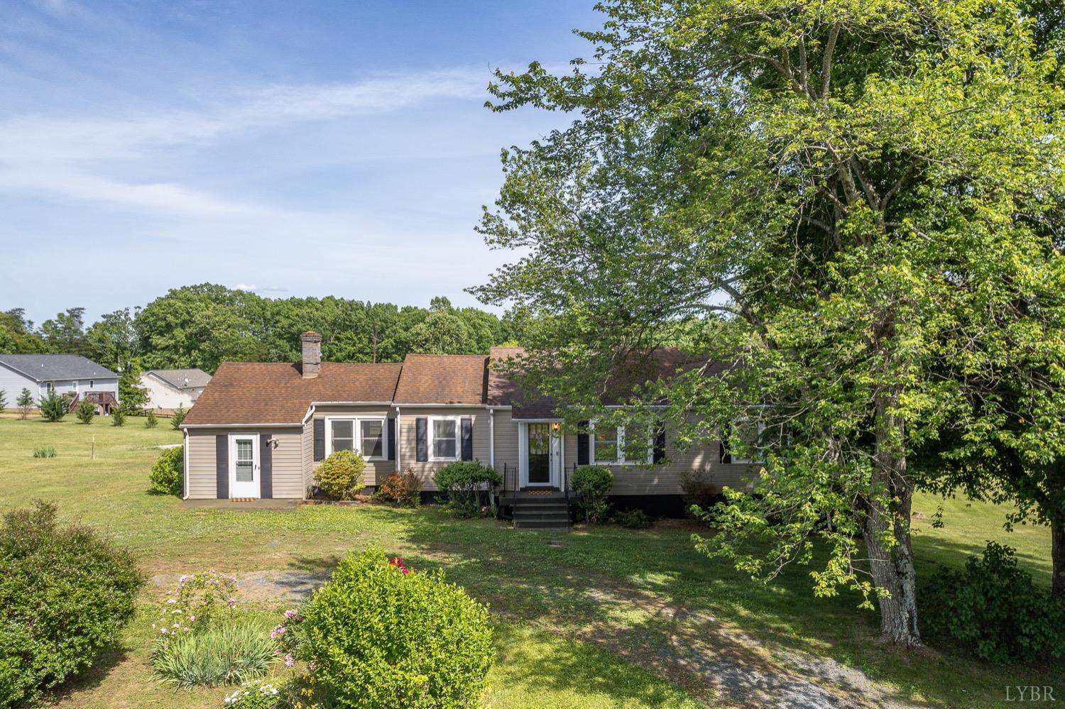 4794 Salem Road Spout Spring, VA 24593 - Photo 33 of 34 a view of a big house with a big yard plants and large trees