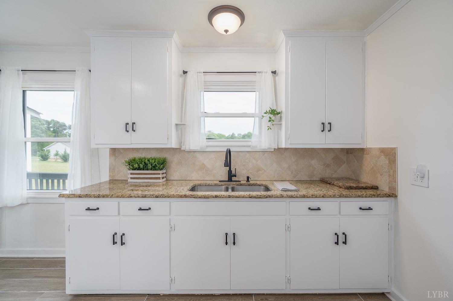 4794 Salem Road Spout Spring, VA 24593 - Photo 7 of 34 a kitchen with granite countertop white cabinets white appliances and a window