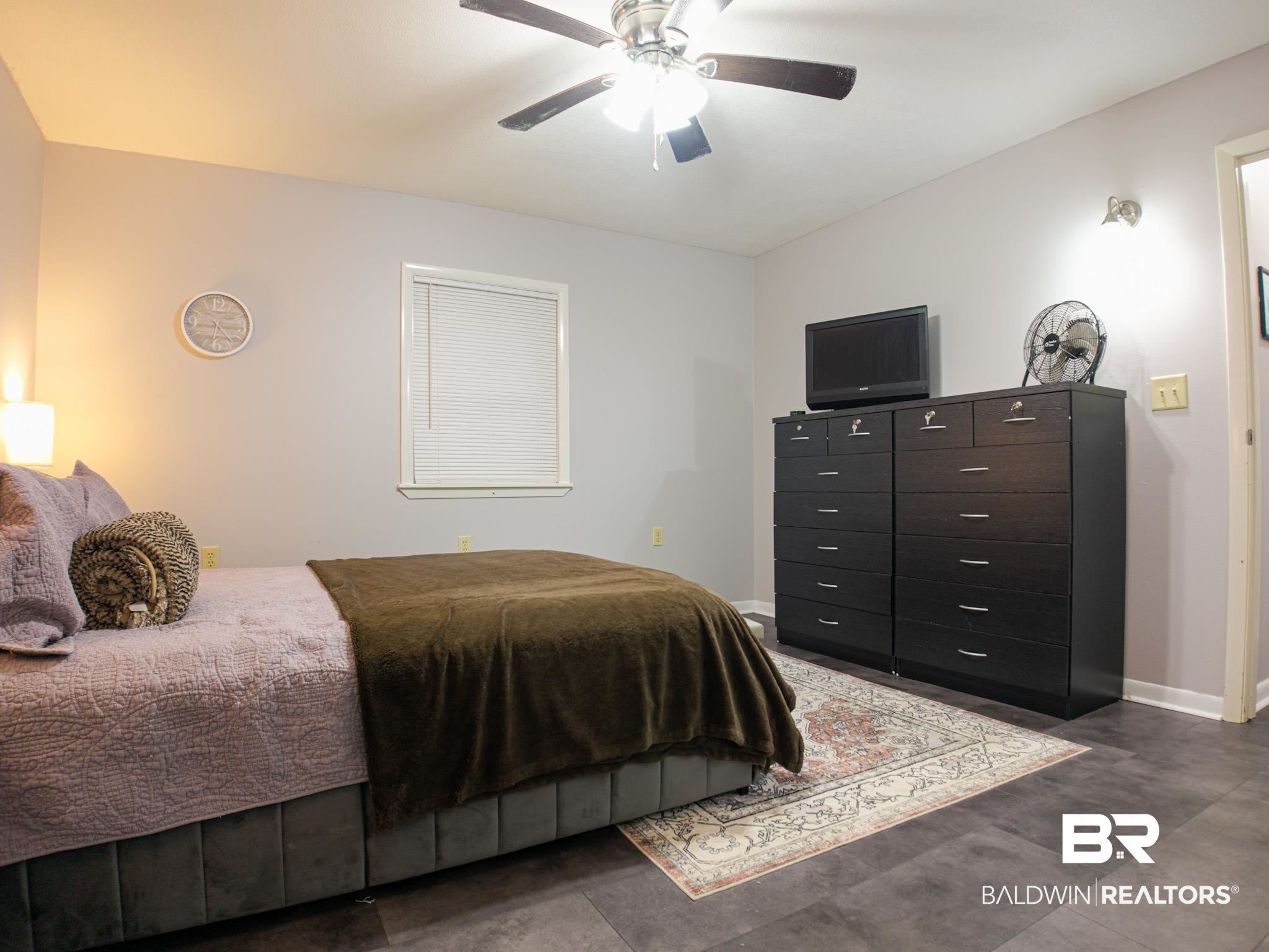 1563 Valencia Drive Lillian, AL 36549 - Photo 15 of 27 Bedroom with baseboards and a ceiling fan