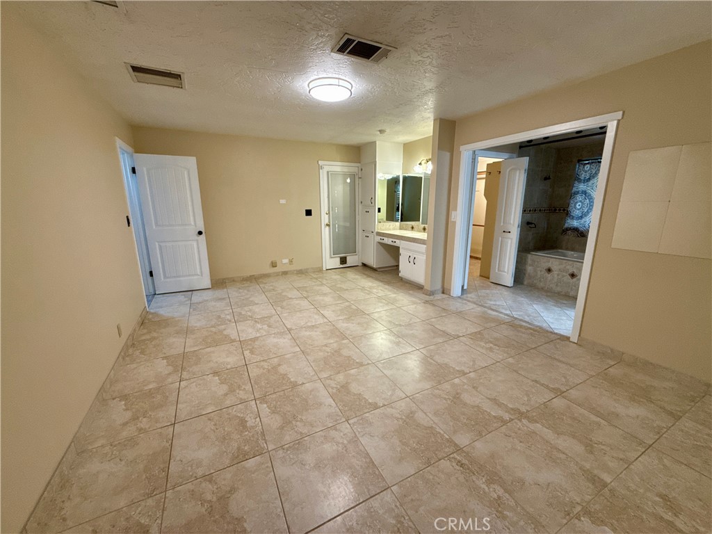14705 Mandan Road Apple Valley, CA 92307 - Photo 12 of 20 a view of a big room with closet and windows