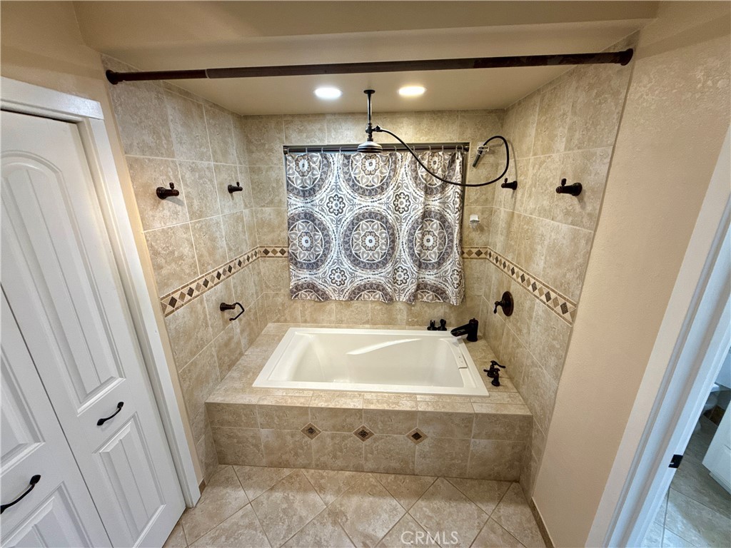 14705 Mandan Road Apple Valley, CA 92307 - Photo 13 of 20 a bathroom with a bathtub and shower
