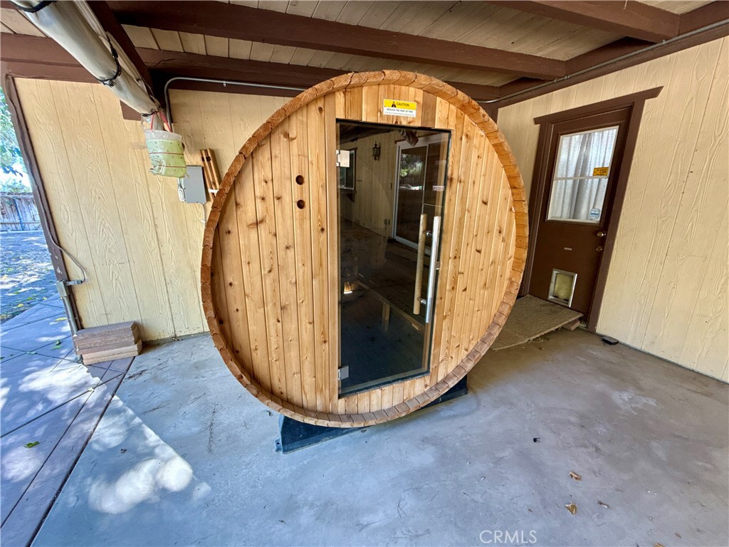 14705 Mandan Road Apple Valley, CA 92307 - Photo 15 of 20 a view of a hallway with wooden walls and stairs