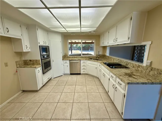 a kitchen with a stove a sink and a refrigerator