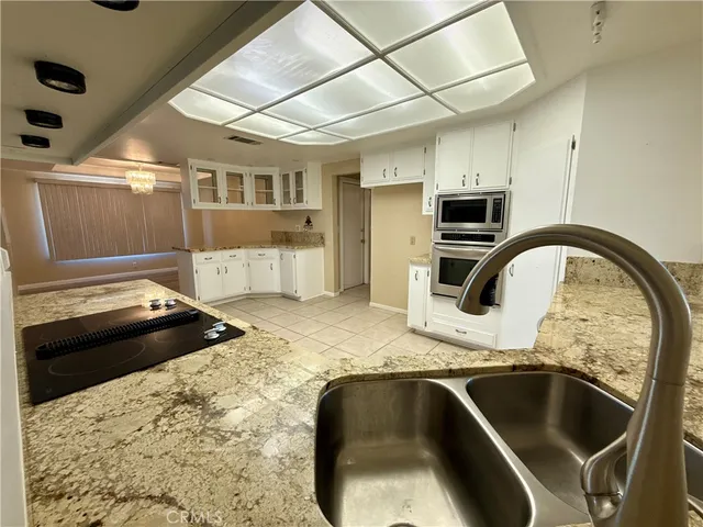 a kitchen with a sink and a stove top oven