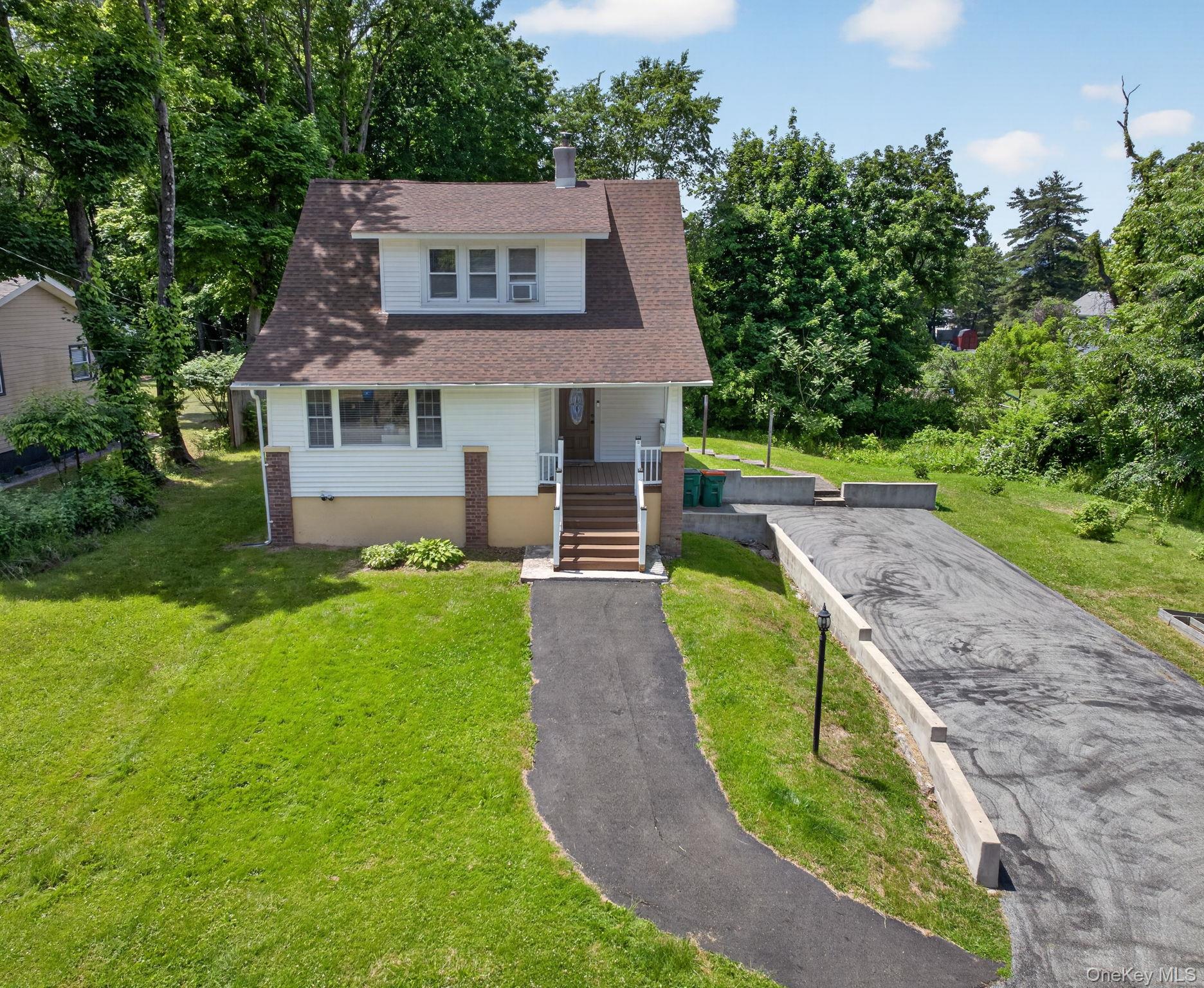 7 Walnut Street Poughkeepsie, NY 12601 - Photo 2 of 30 Its classic design features a welcoming front porch, dormer windows, and a warm, inviting exterior that instantly feels like home.