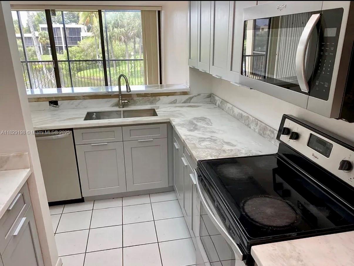 2941 Southwest 87th Avenue, Unit 406 Davie, FL 33328 - Photo 3 of 16 a kitchen with a stove and a sink
