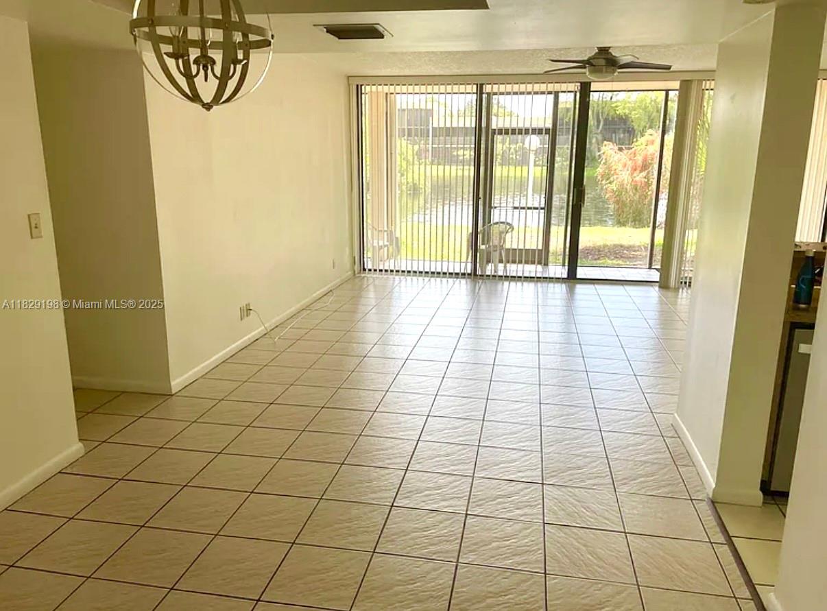 2941 Southwest 87th Avenue, Unit 406 Davie, FL 33328 - Photo 4 of 16 a view of empty room with wooden floor and fan