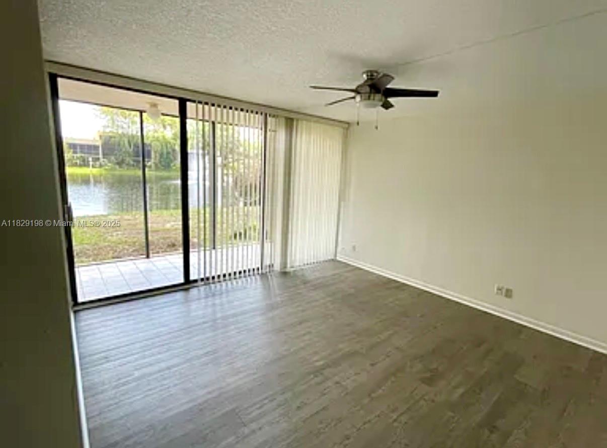 2941 Southwest 87th Avenue, Unit 406 Davie, FL 33328 - Photo 6 of 16 an empty room with wooden floor and windows