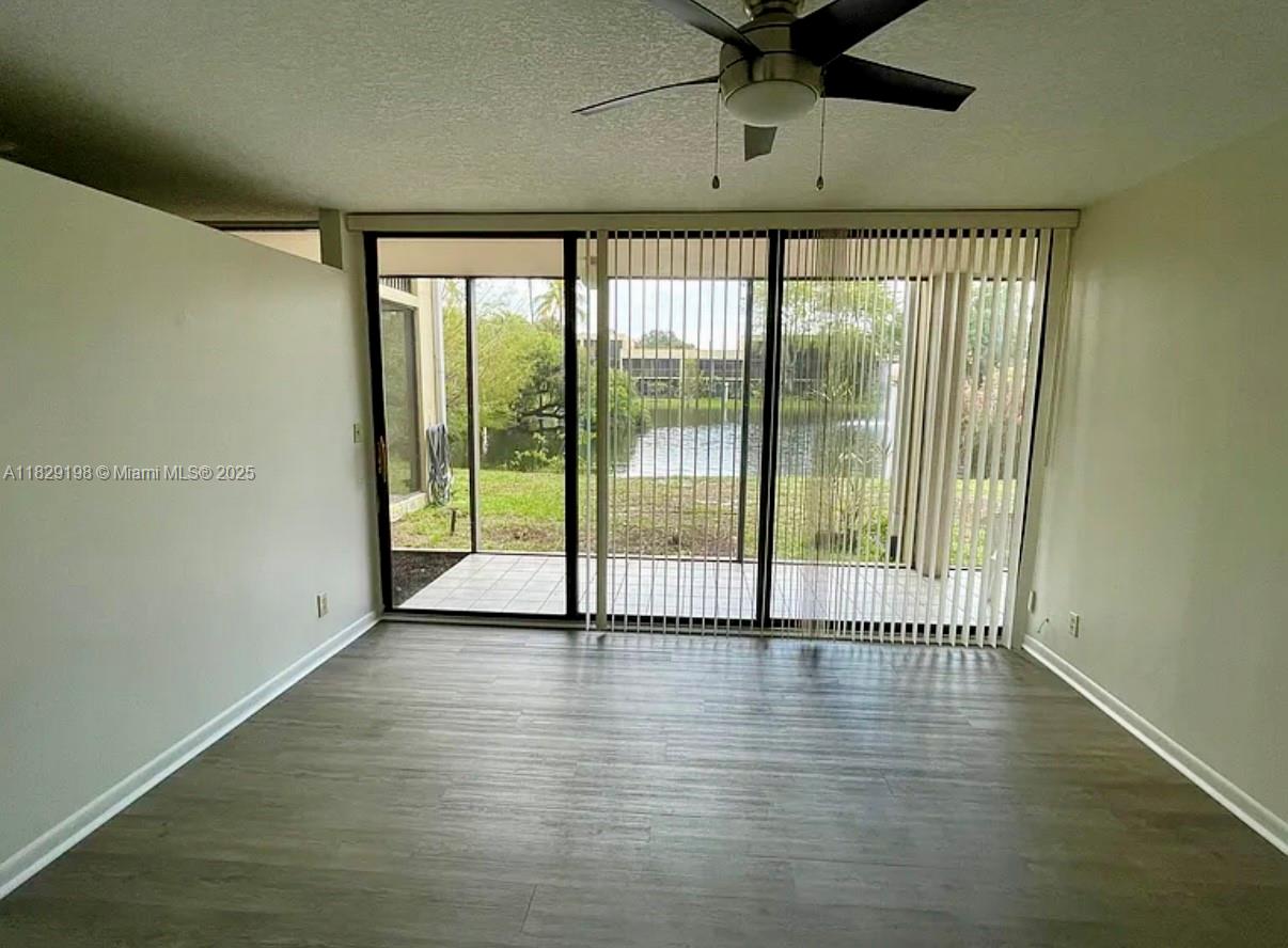 2941 Southwest 87th Avenue, Unit 406 Davie, FL 33328 - Photo 9 of 16 wooden floor in an empty room with a window