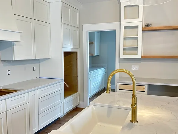 a kitchen with kitchen island a sink stainless steel appliances and cabinets