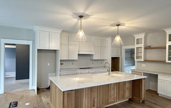 a kitchen with white cabinets and white appliances