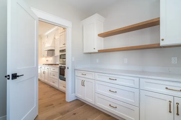 a kitchen with stainless steel appliances granite countertop a sink a stove and a wooden floors