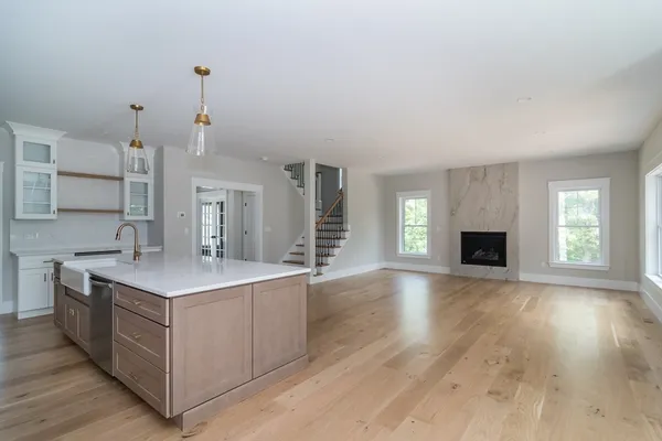 an empty room with windows and fireplace