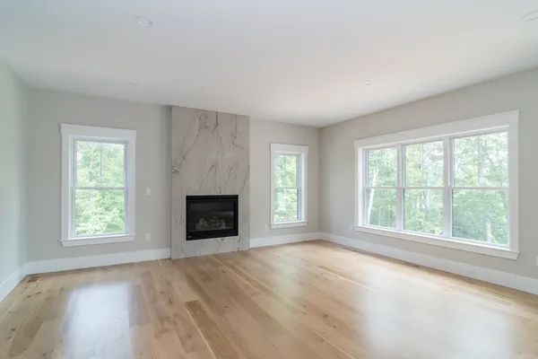 a kitchen with stainless steel appliances a refrigerator a sink dishwasher a stove and white cabinets with wooden floor