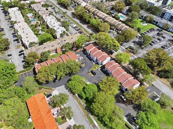 an aerial view of a house with a yard and lake view