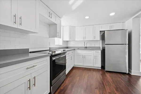 a kitchen with a white cabinets and white appliances