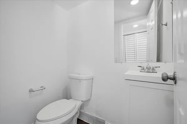a bathroom with a toilet sink and mirror