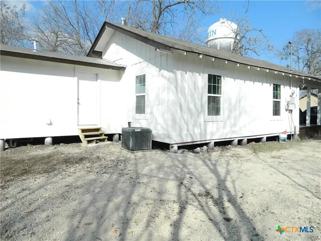 a view of a livingroom with furniture and a window