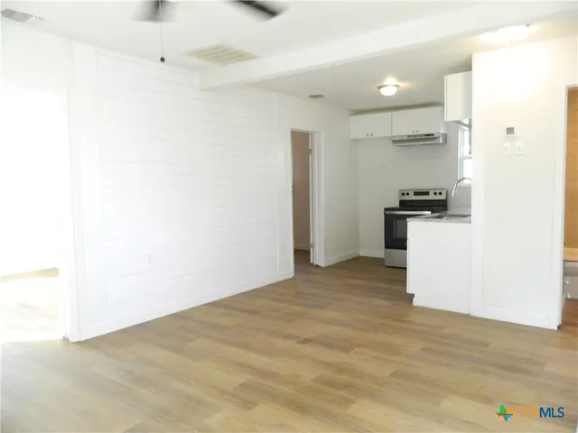 a view of a kitchen with a refrigerator a stove top oven and a refrigerator