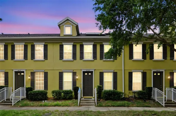 a front view of a residential apartment building with a yard