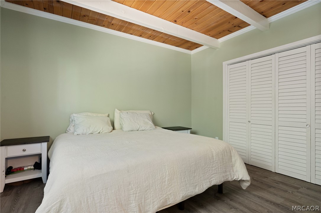 316 Pioneer Road Lake Arrowhead, CA 92352 - Photo 11 of 35 a large bed sitting in a bedroom next to a window