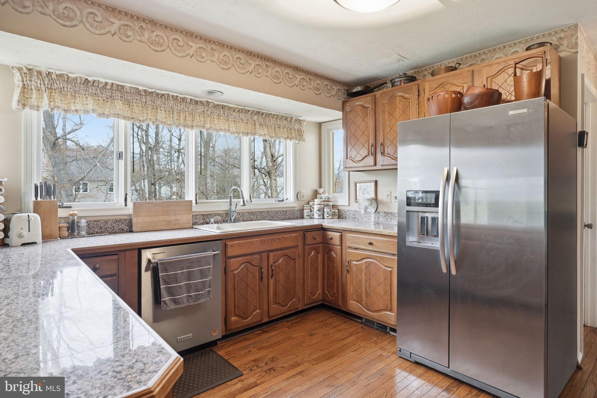7 Wickham Court Sterling, VA 20165 - Photo 12 of 44 a kitchen with stainless steel appliances granite countertop a refrigerator a sink and white cabinets