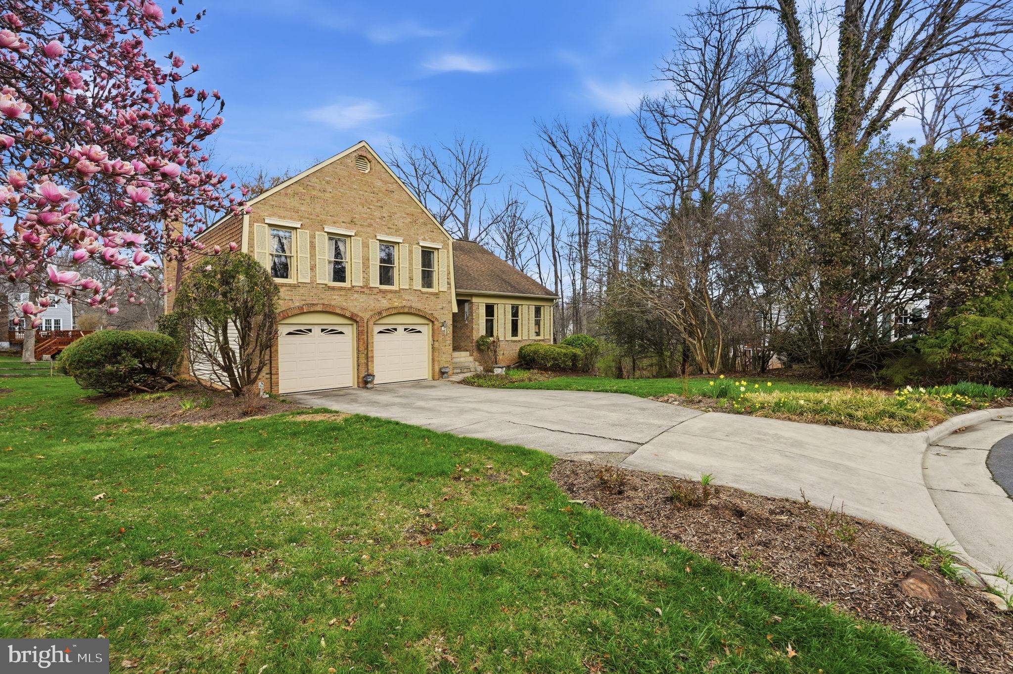 7 Wickham Court Sterling, VA 20165 - Photo 2 of 44 a front view of a house with a yard and trees