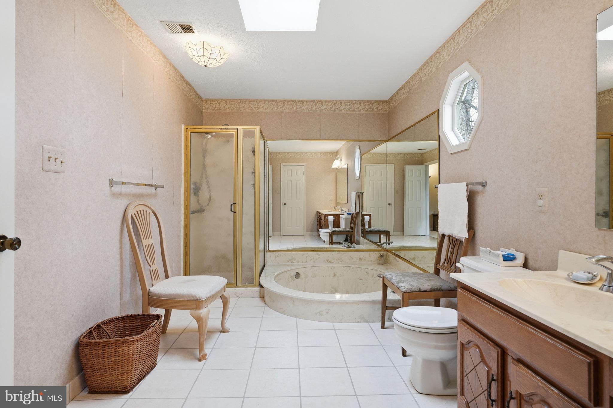 7 Wickham Court Sterling, VA 20165 - Photo 25 of 44 a spacious bathroom with a bathtub shower sink mirror and toilet