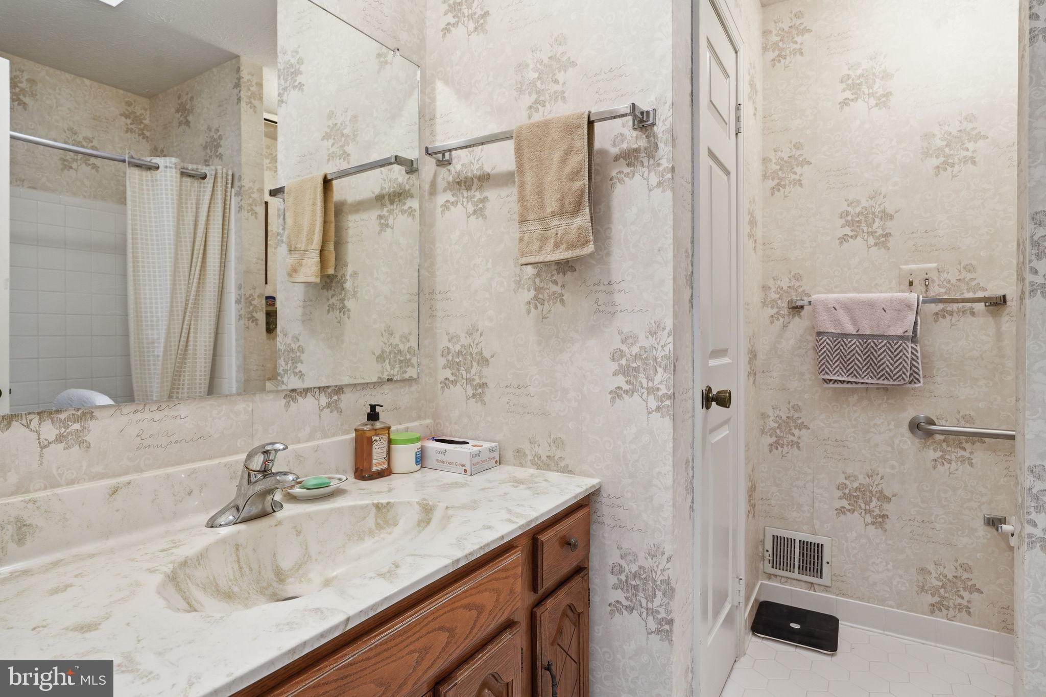 7 Wickham Court Sterling, VA 20165 - Photo 29 of 44 a bathroom with a granite countertop shower sink and vanity