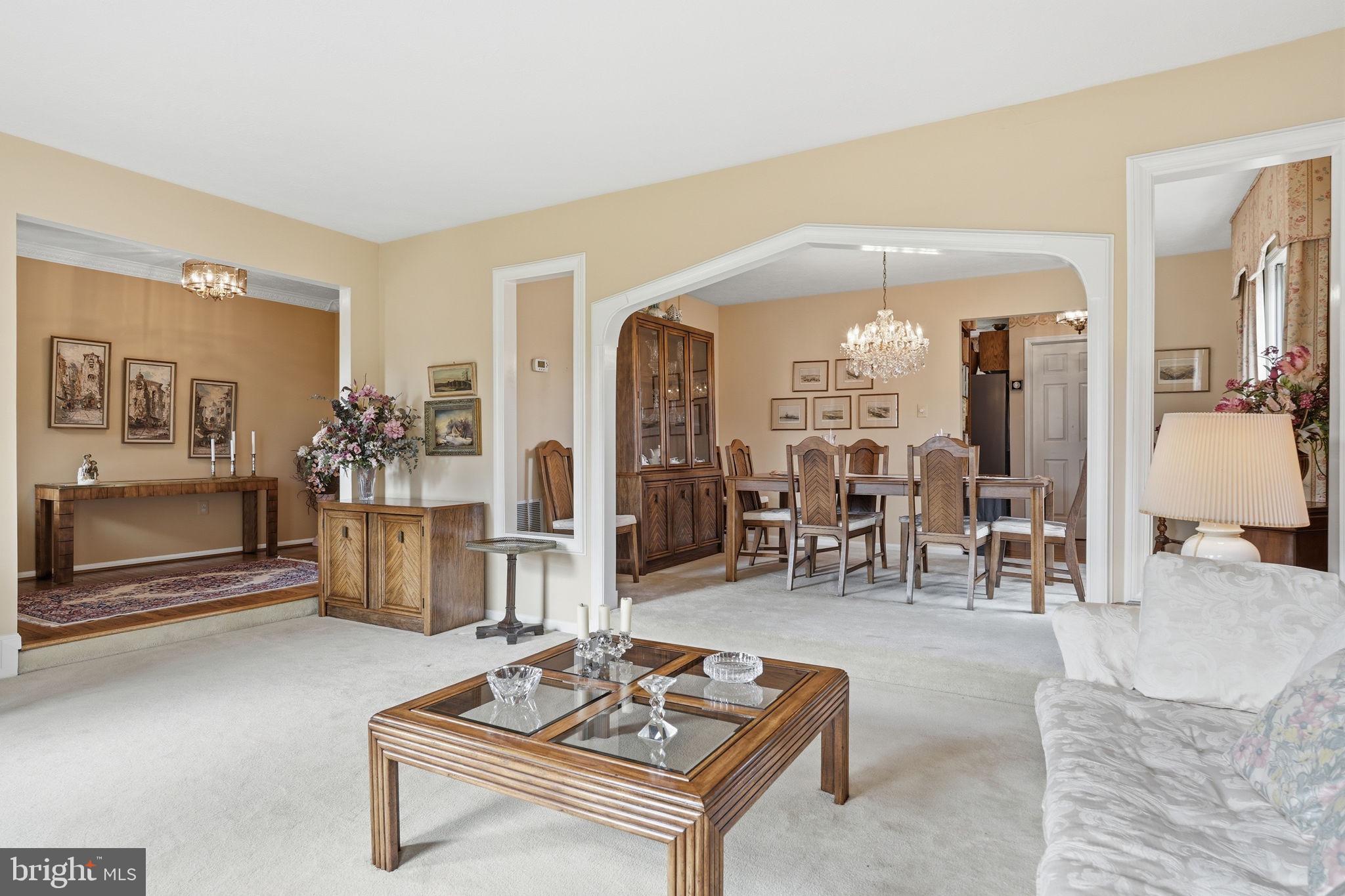 7 Wickham Court Sterling, VA 20165 - Photo 7 of 44 a living room with furniture a chandelier and a table