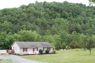 2575 Split Rail Road Shawsville, VA 24162 - Photo 1 of 25 a view of a big house in a big yard with large trees
