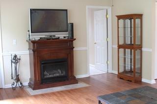 2575 Split Rail Road Shawsville, VA 24162 - Photo 5 of 25 a living room with a fireplace and a flat screen tv