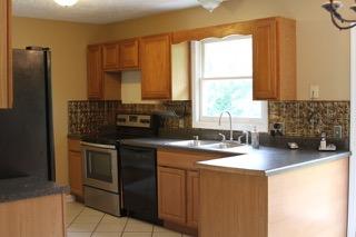 2575 Split Rail Road Shawsville, VA 24162 - Photo 7 of 25 a kitchen with a sink stove and refrigerator