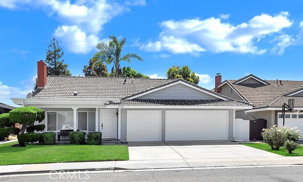 20542 Bearsden Circle Huntington Beach, CA 92646 - Photo 1 of 16 a front view of a house with a garden