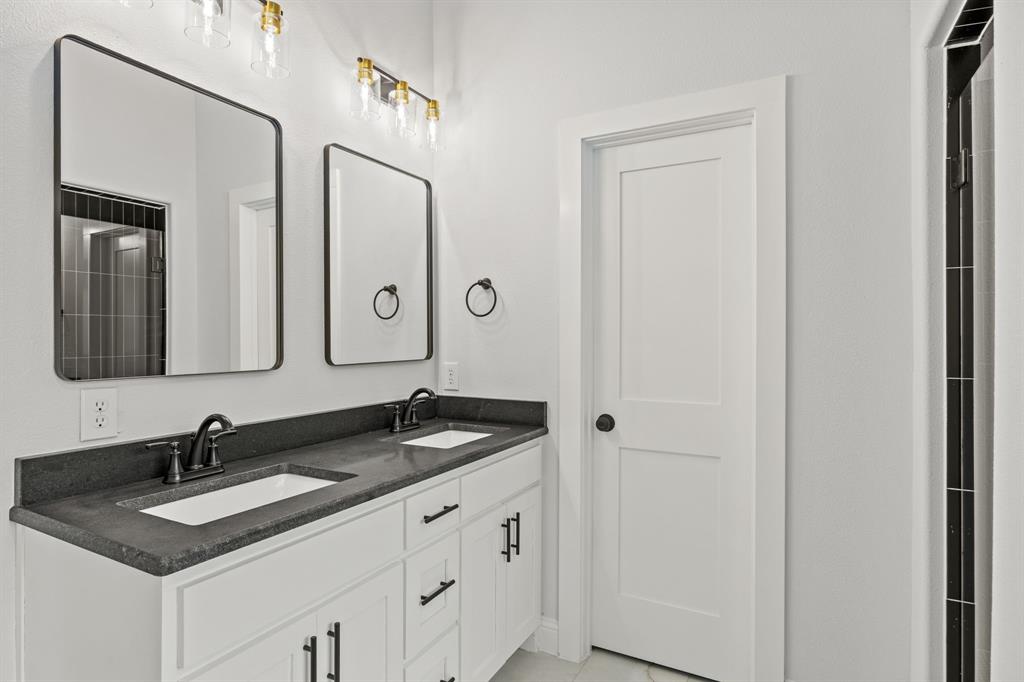 104 Maverick Trail Valley View, TX 76272 - Photo 19 of 30 a bathroom with double sink and a mirror