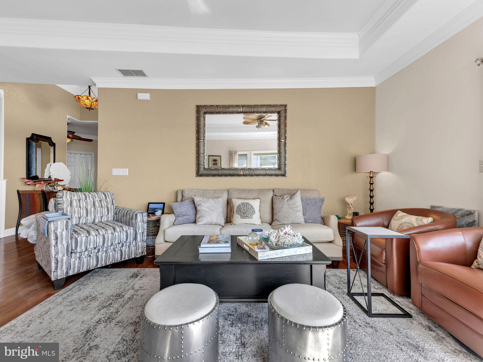 12608 Selsey Road Ocean City, MD 21842 - Photo 11 of 66 a dining room with furniture a rug and a chandelier