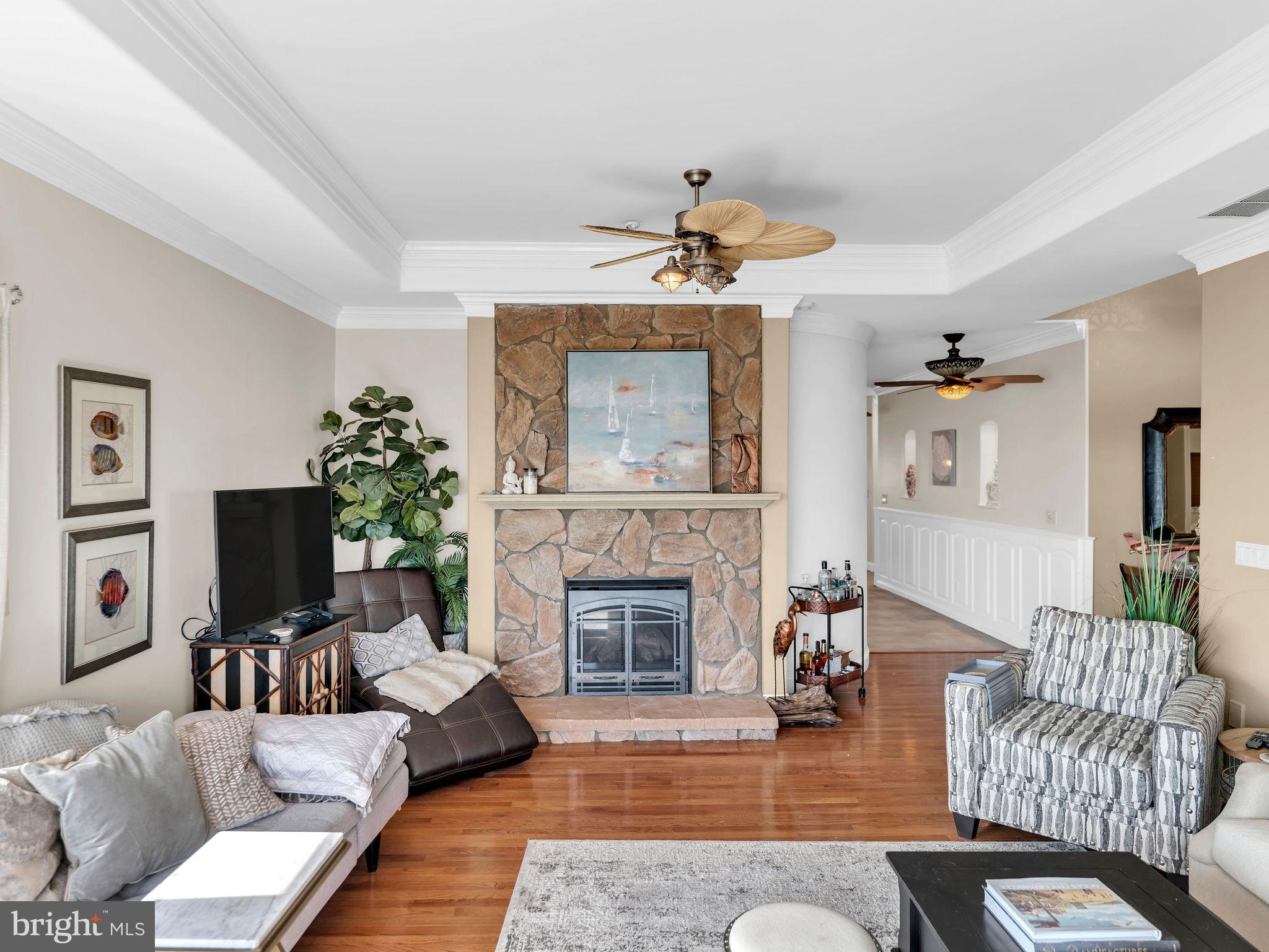 12608 Selsey Road Ocean City, MD 21842 - Photo 12 of 66 a living room with furniture a fireplace and a flat screen tv