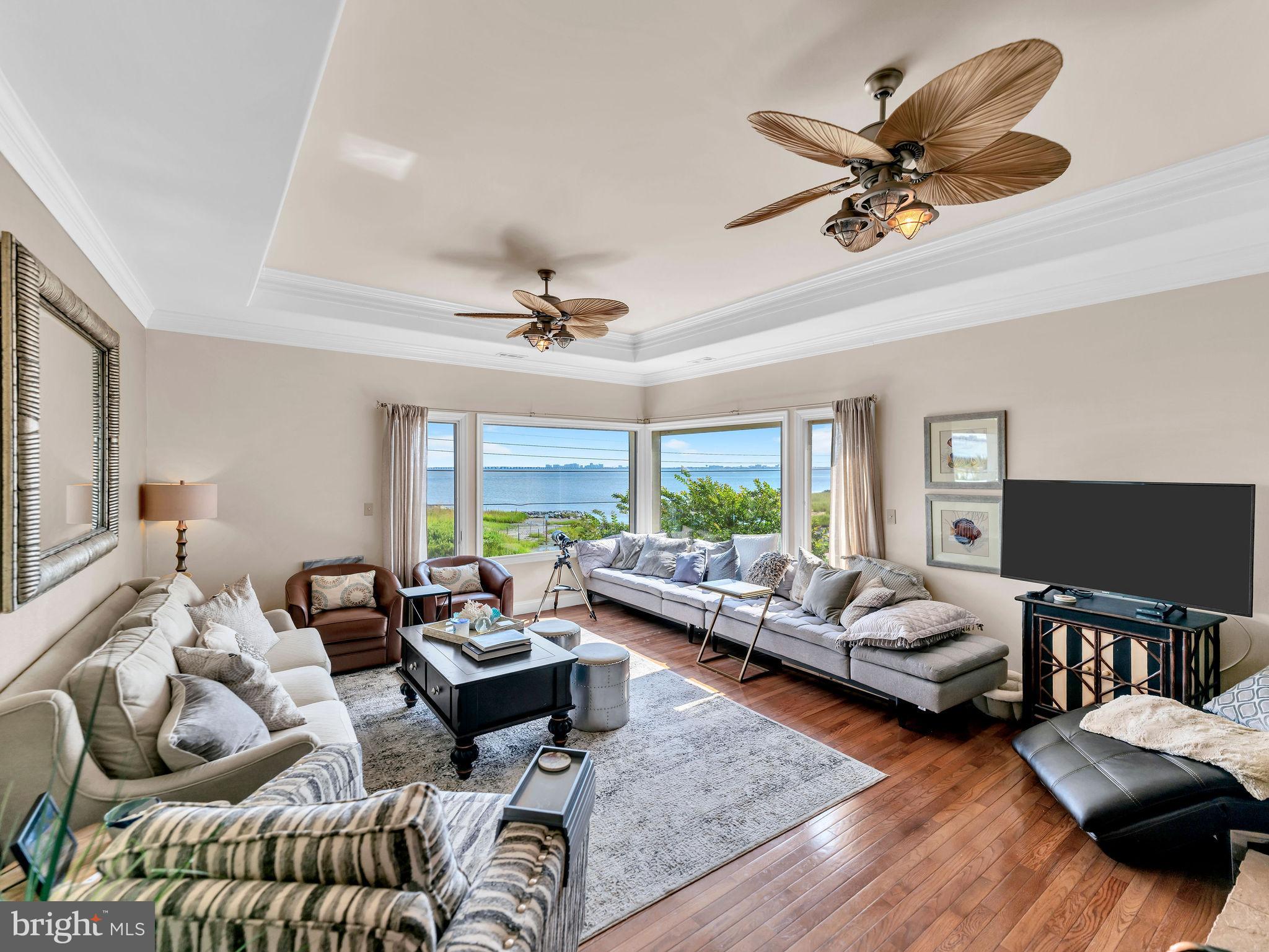 12608 Selsey Road Ocean City, MD 21842 - Photo 2 of 66 a living room with furniture ceiling fan and a window