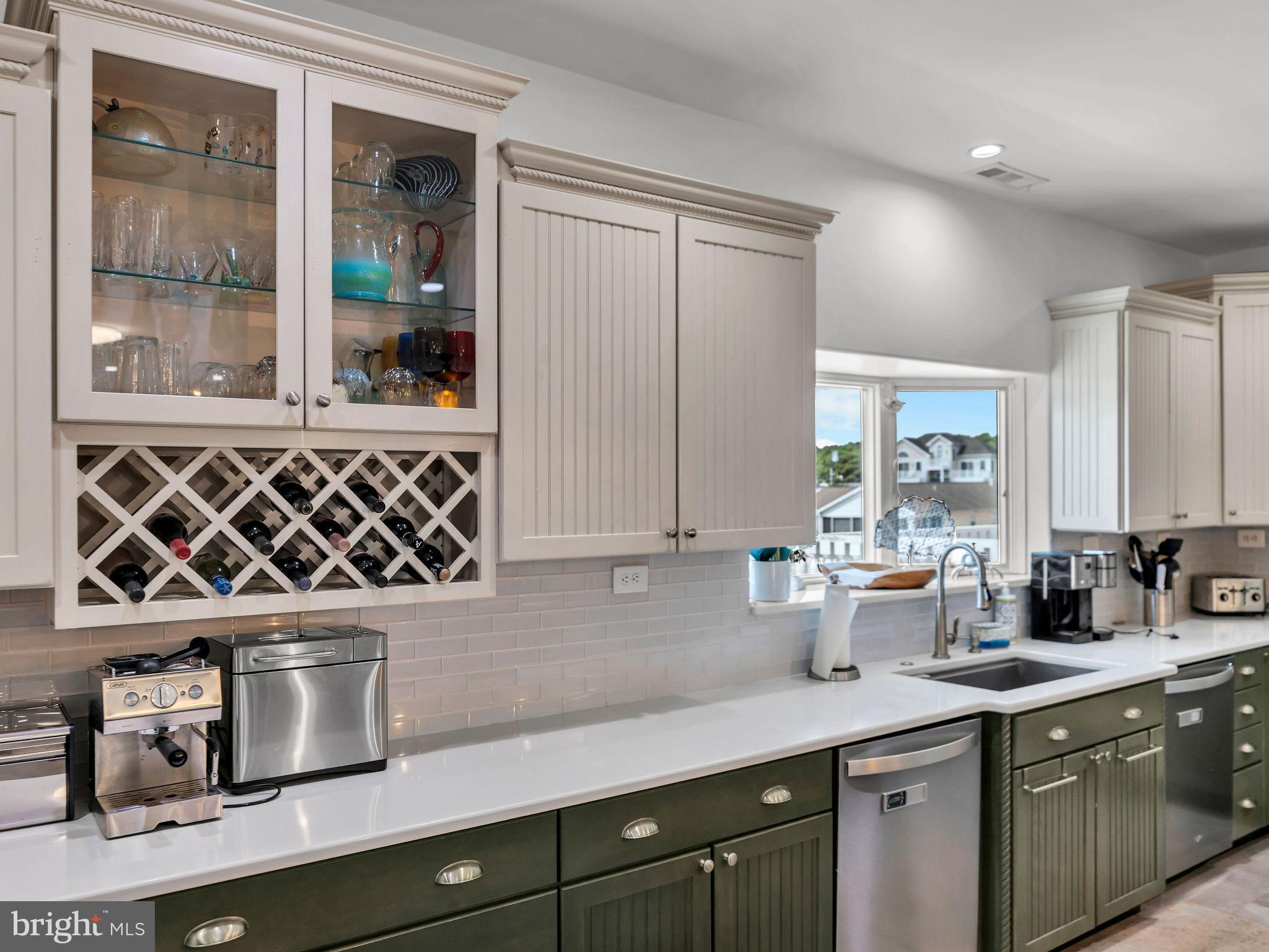12608 Selsey Road Ocean City, MD 21842 - Photo 24 of 66 a kitchen with a sink and wooden cabinets