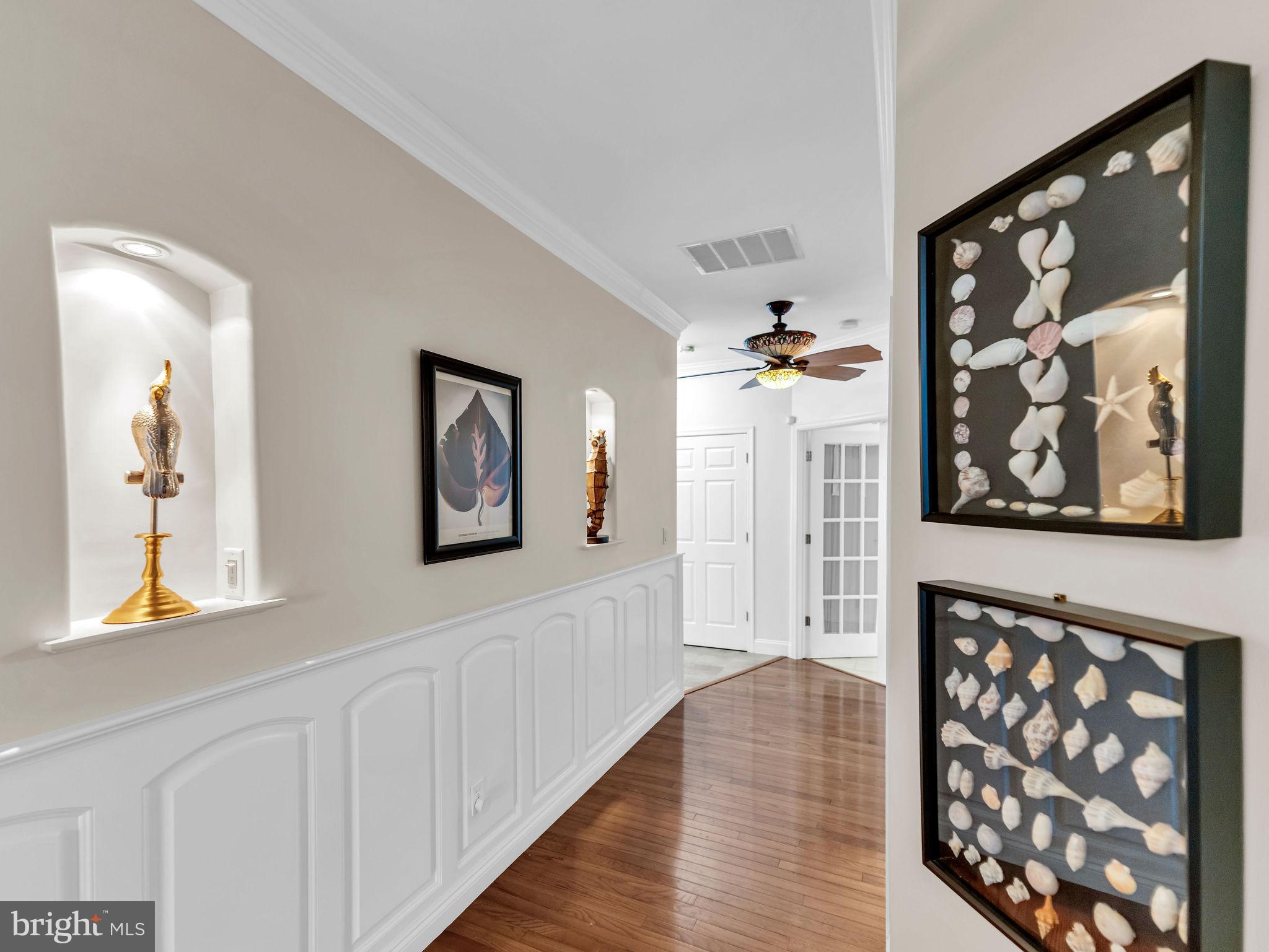 12608 Selsey Road Ocean City, MD 21842 - Photo 25 of 66 a hallway with wooden floor and windows